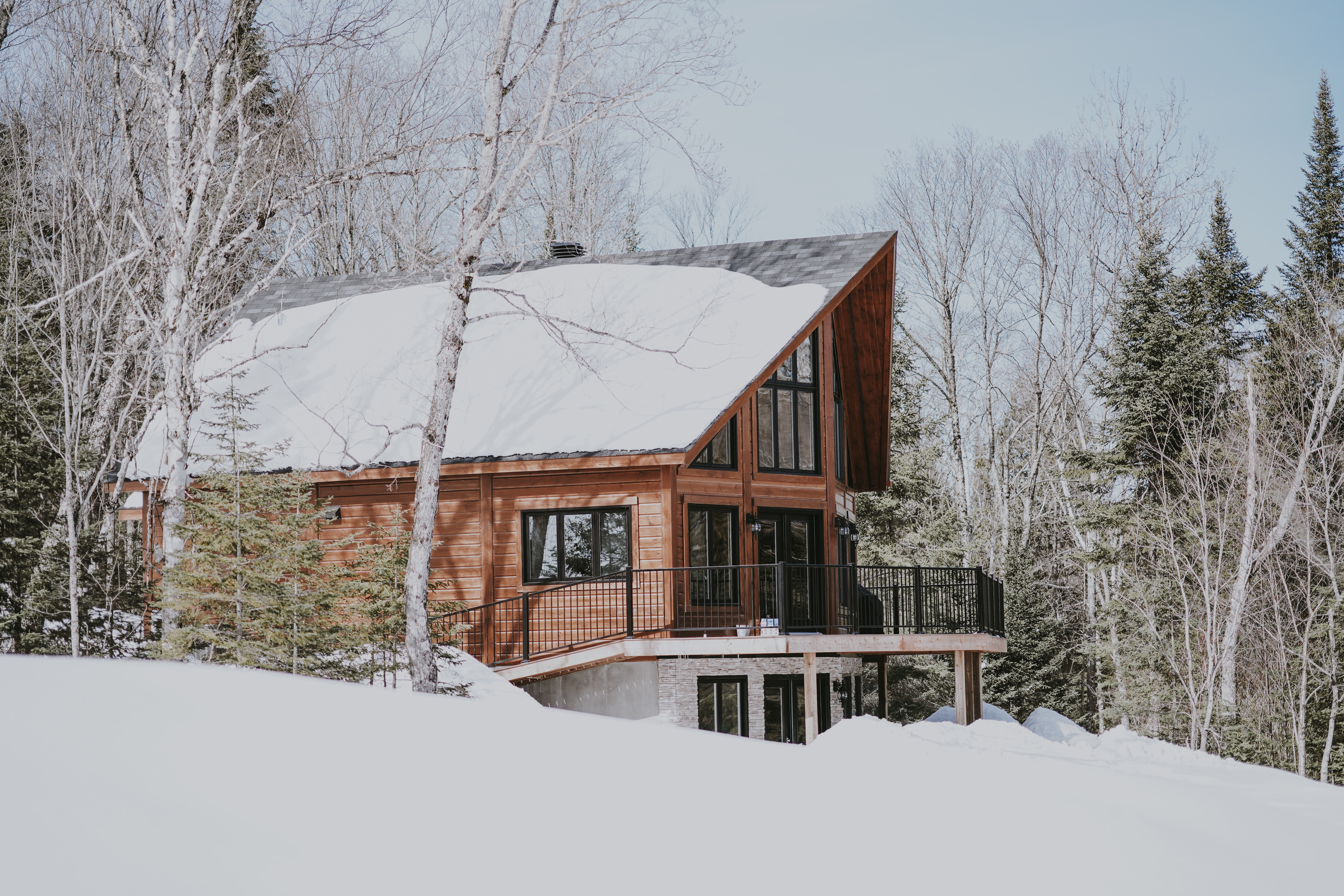 a fresh layer of snow sits on a gorgeous chalet style home